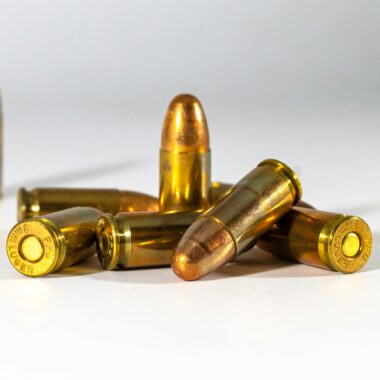A still life of bullets displayed on a white background, highlighting their metallic texture and shape.