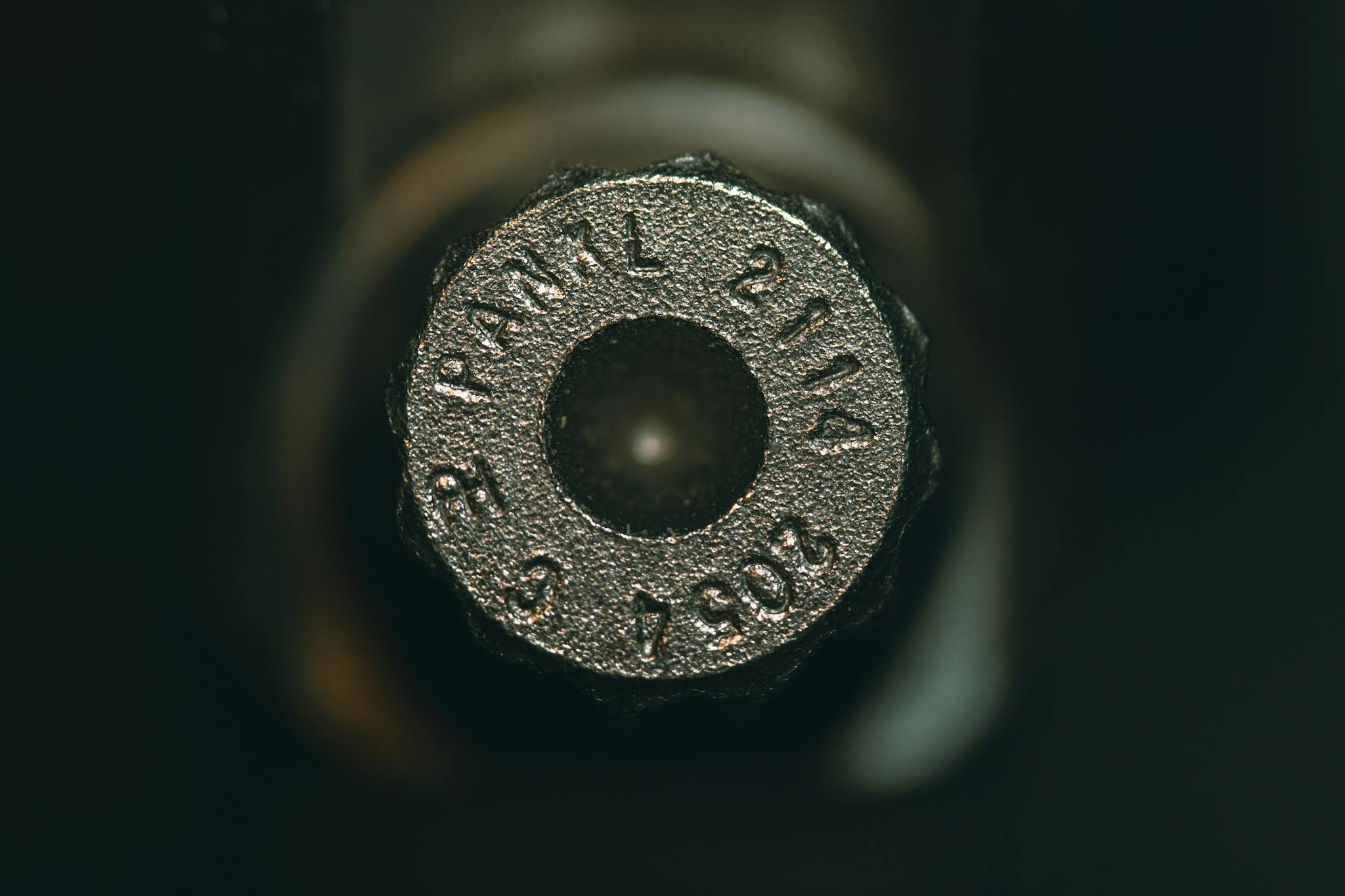 Detailed view of a metallic ammunition cartridge with engraved numbers.